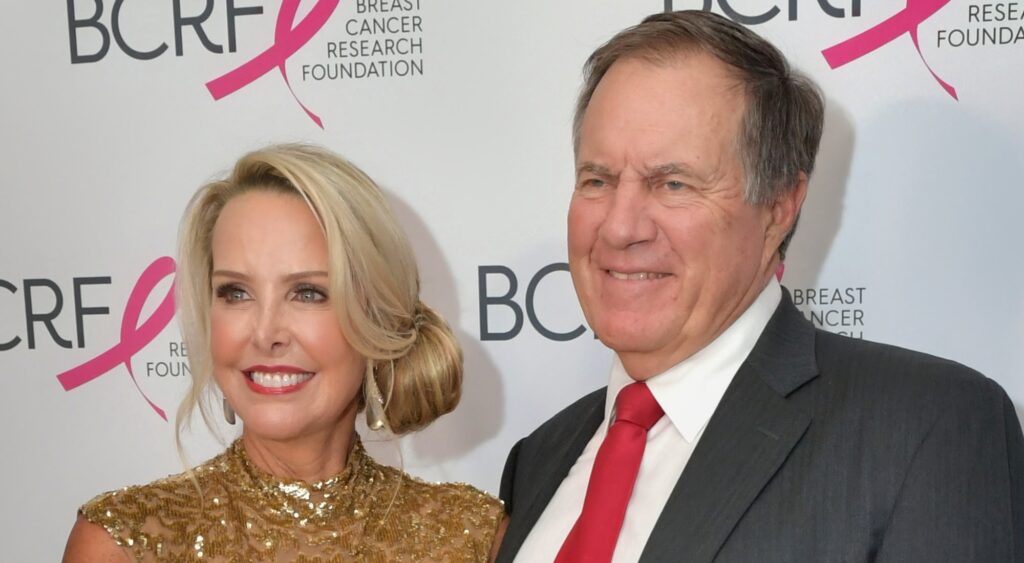 Linda Holliday and Bill Belichick looking on at event.