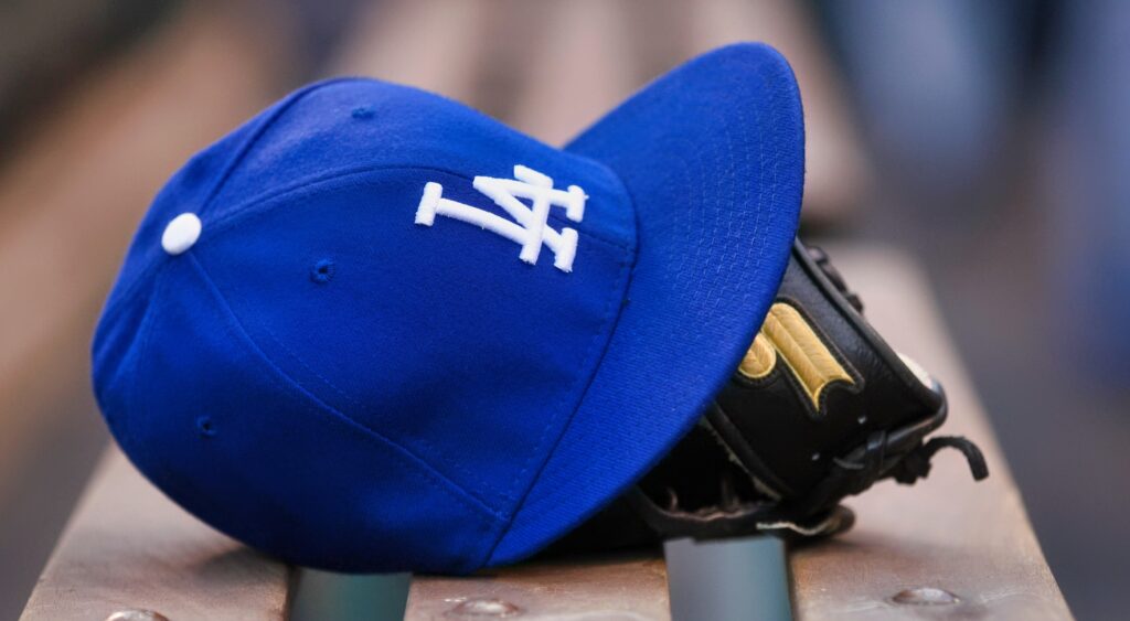 Dodgers cap and glove on bench