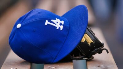 Dodgers cap and glove on bench