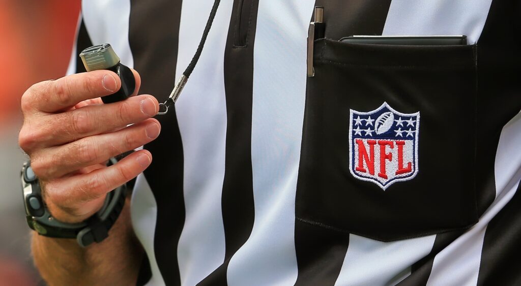 NFL referee holding his whistle. LASIK took a savage shot at the refs following TNF