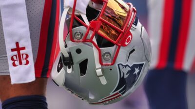 Patriots helmet being held