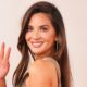 Olivia Munn waving and posing