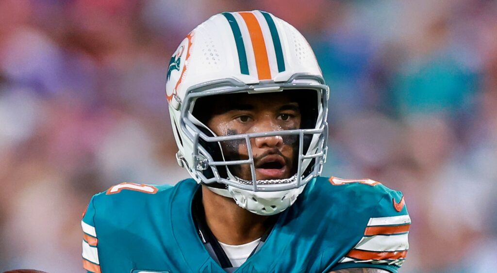 Miami Dolphins quarterback Tua Tagovailoa looking on.