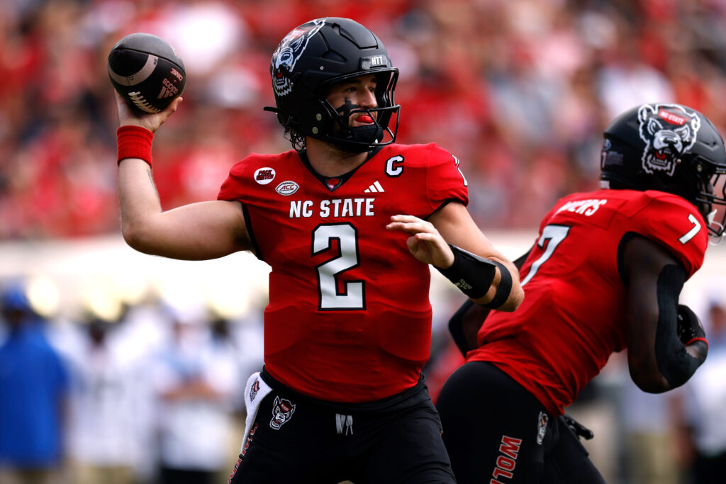 Grayson McCall throwing a football