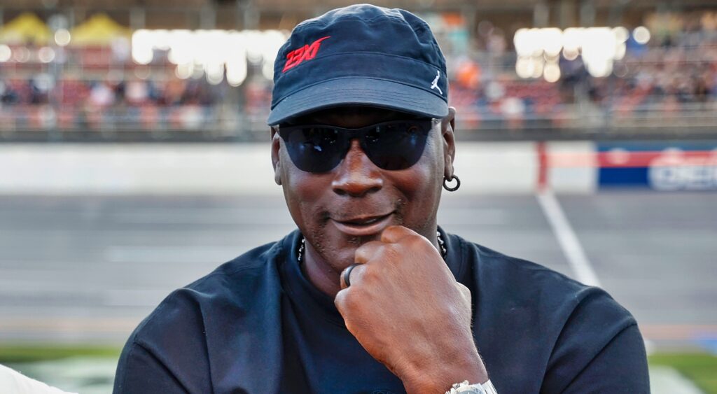 Michael Jordan poses for the camera at a NASCAR race.