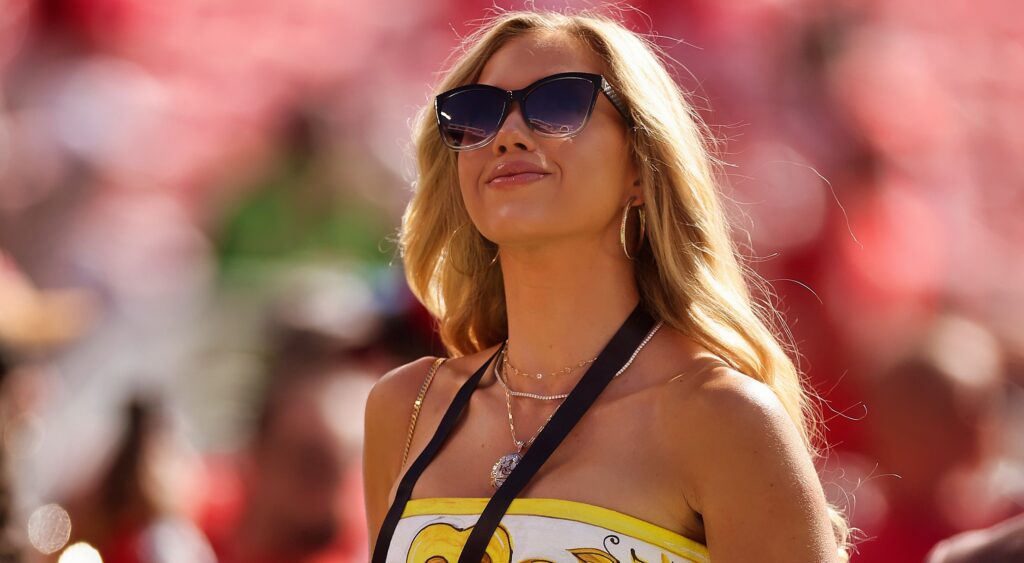 Gracie Hunt on NFL sidelines wearing sunglasses