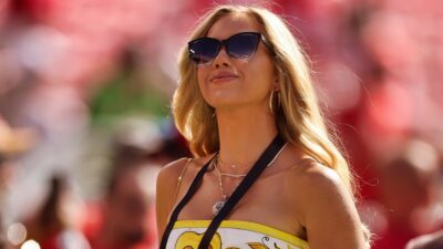 Gracie Hunt on NFL sidelines wearing sunglasses