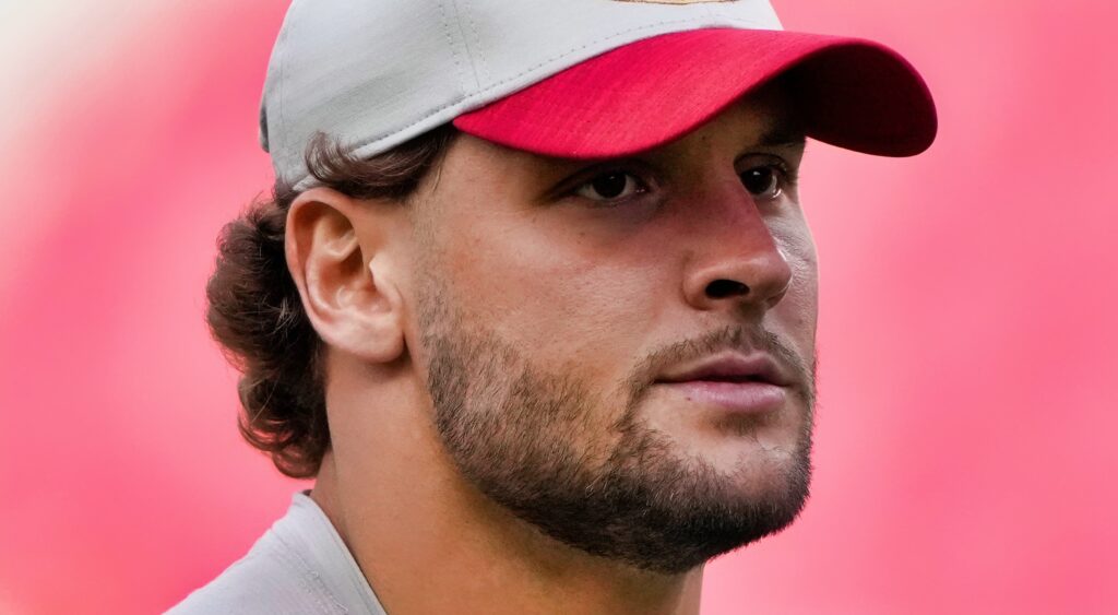 Nick Bosa looks on.