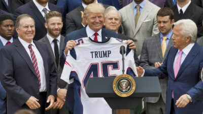 Donald Trump standing between Bill belichick and Robert Kraft