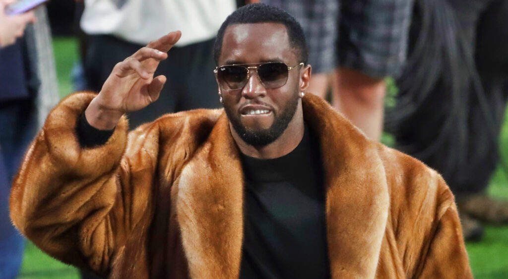 Diddy smiling and saluting