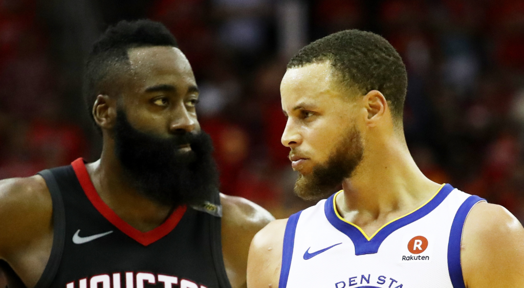 Stephen Curry of the Golden State Warriors reacts as James Harden of the Houston Rockets looks on in the third quarter of Game Seven of the Western Conference Finals of the 2018 NBA Playoffs