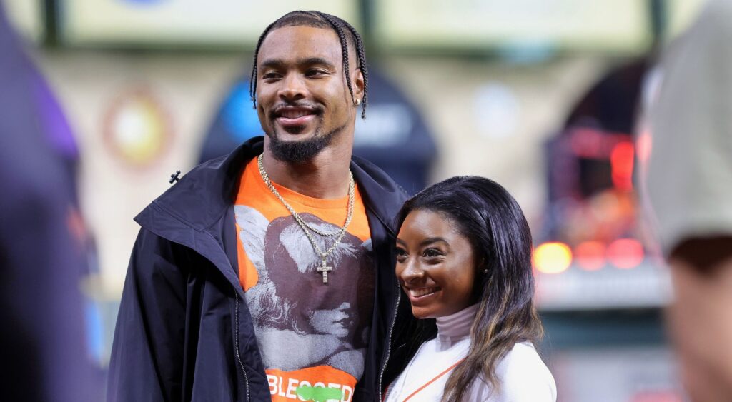 Simone Biles and Jonathan Owens pose on the field prior to Game One of the 2022 World Series between the Philadelphia Phillies and the Houston Astros 