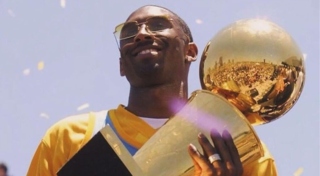 Kobe Bryant with NBA Championship trophy