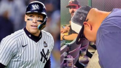 New York Yankees fan in stands and Aaron Judge on field