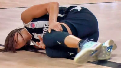 Nika Muhl lying on the court after knee injury