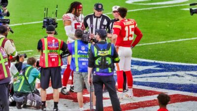 Referee Bill Vinovich talks to linebacker Fred Warner of the San Francisco 49ers and quarterback Patrick Mahomes of the Kansas City Chiefs.