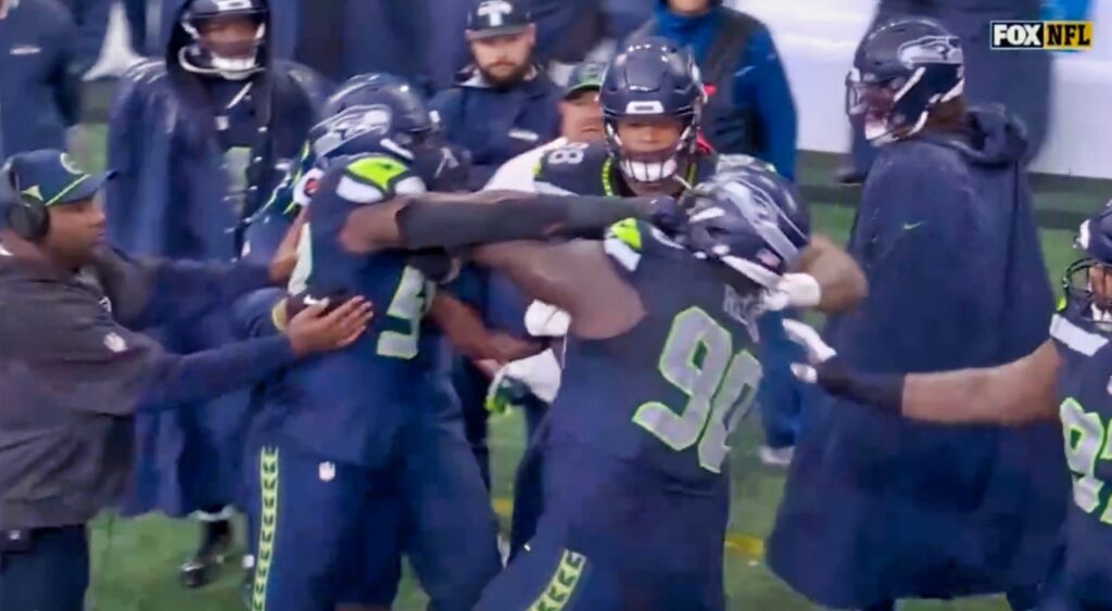 Derick Hall and Jarran Reed fighting on the Seahawks sideline.