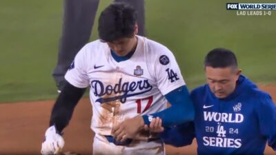 Shohei Ohtani walking off with trainer