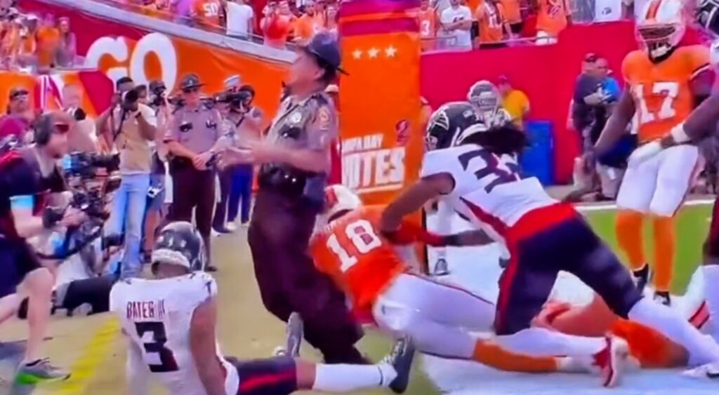 State trooper gets hit while standing along the back of the end zone during Bucs-Falcons game.