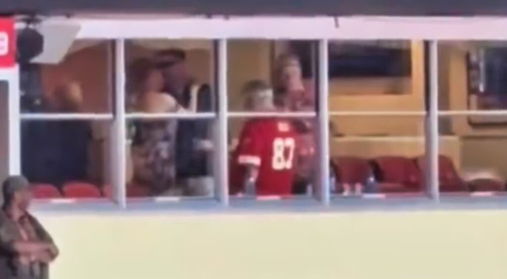 Travis Kelce and Taylor Swift in their suite with their dads.