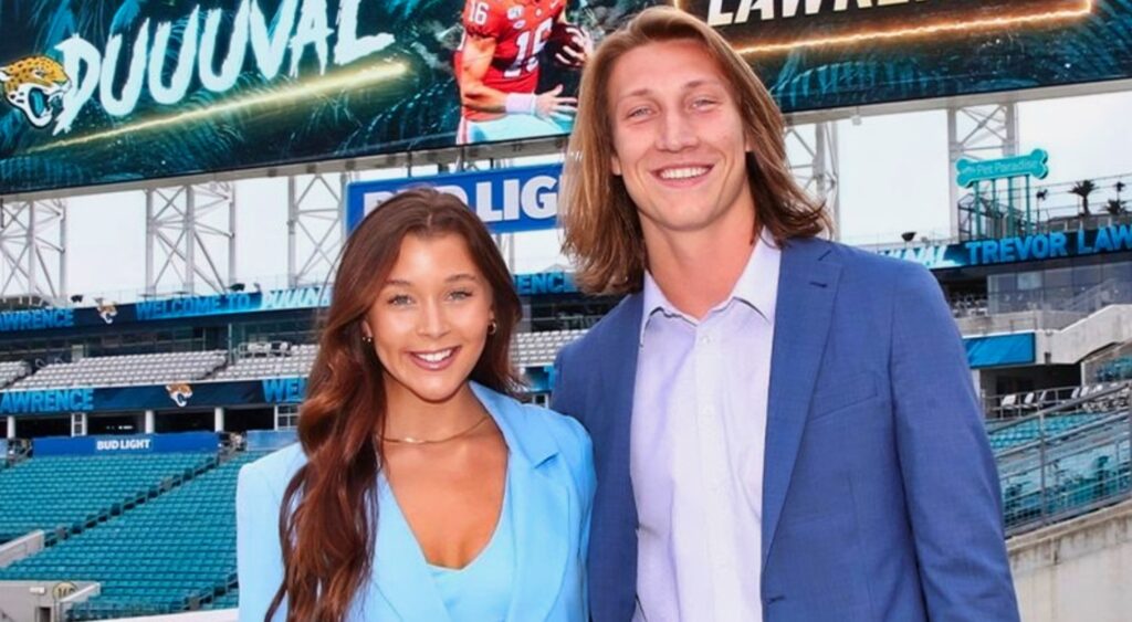 Marissa and Trevor Lawrence pose together inside the Jaguars stadium.