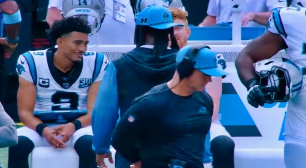 Bryce Young of Carolina Panthers talking to Andy Dalton on the sidelines.