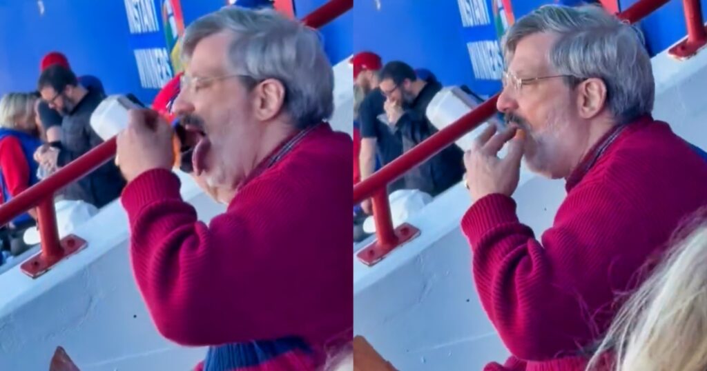 Buffalo Bills fan eating salmon at game.