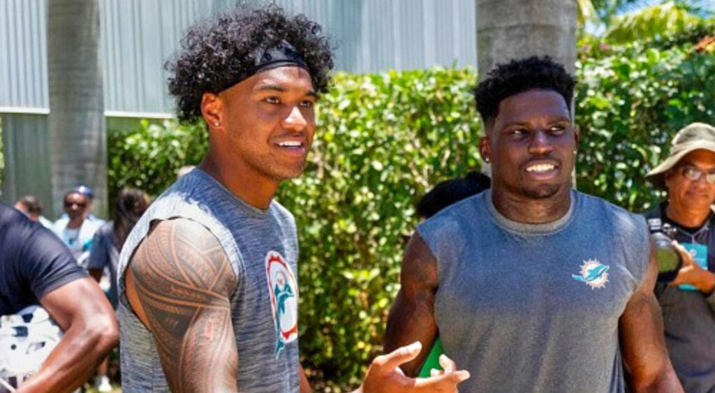 Tua Tagovailoa standing next to Tyreek Hill