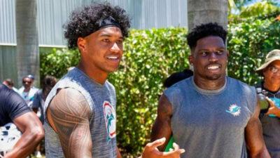 Tua Tagovailoa standing next to Tyreek Hill