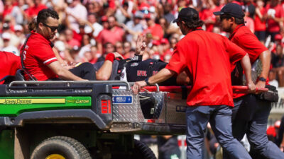 Grayson McCall being carted off