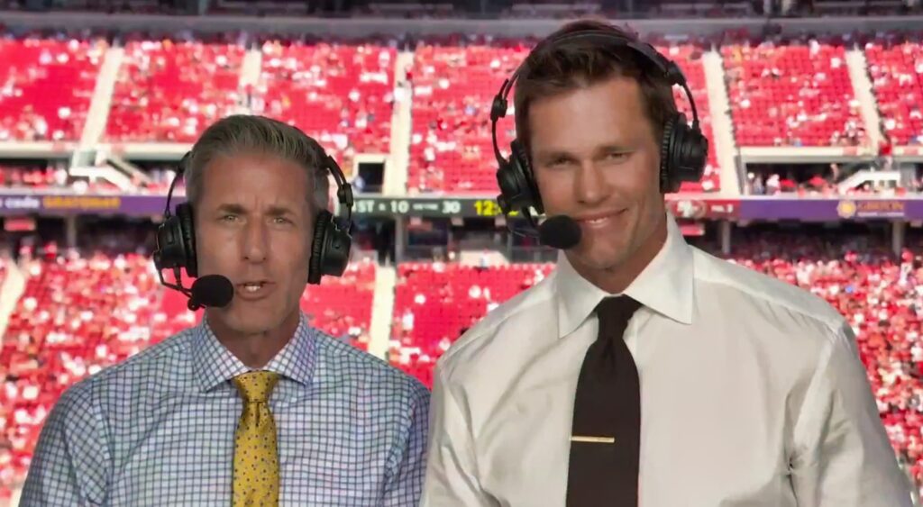 Kevin Burkhardt and Tom Brady speaking in NFL broadcast booth.