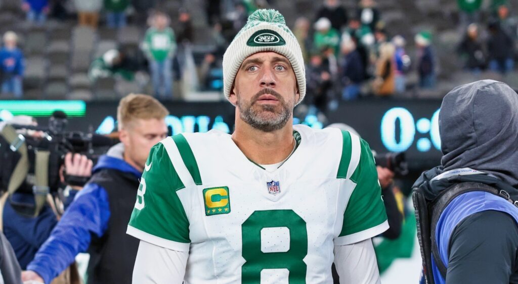 Aaron Rodgers of the New York Jets walks on the field after an NFL game