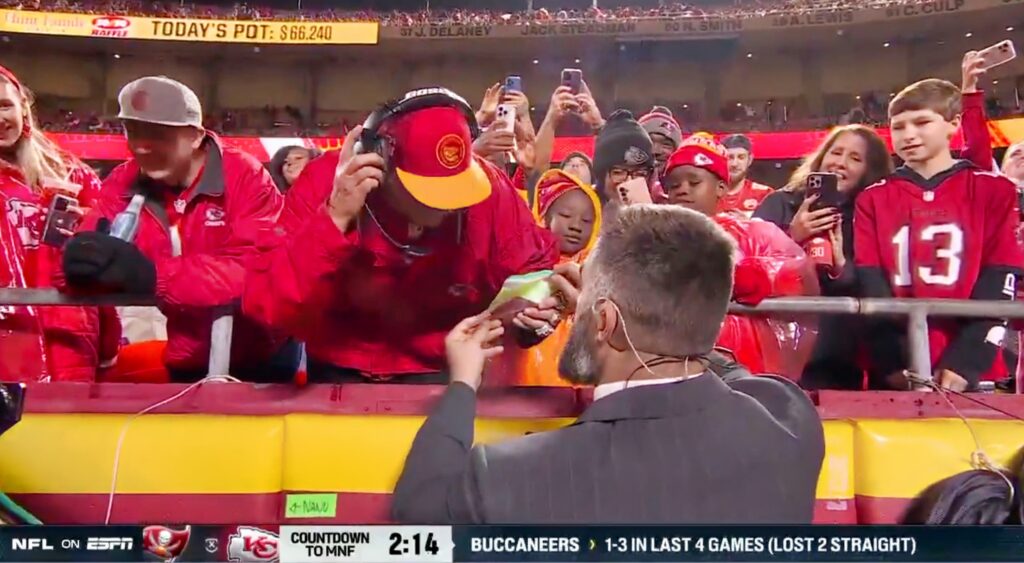 Jason Kelce gives Andy Reid lookalike his prize.