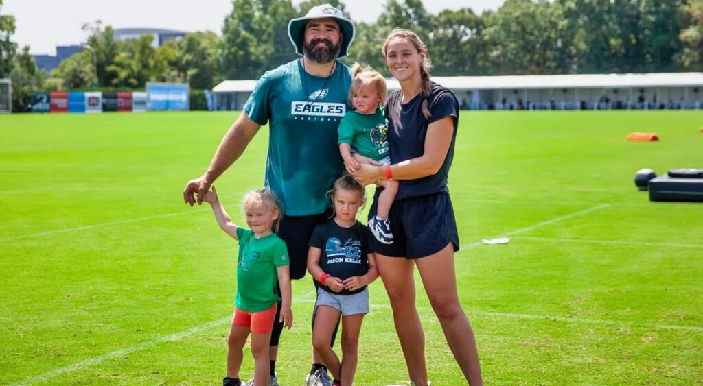 Jason and Kylie Kelce posing with their daughters