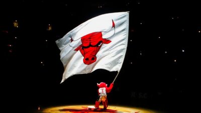 Benny the Bull, mascot for the Chicago Bulls, waves a giant flag with the Bulls' logo on it