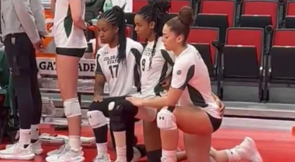 Colorado State volleyball players kneeling