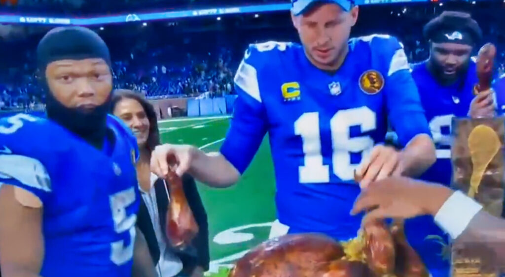 David Montgomery standing next to turkey