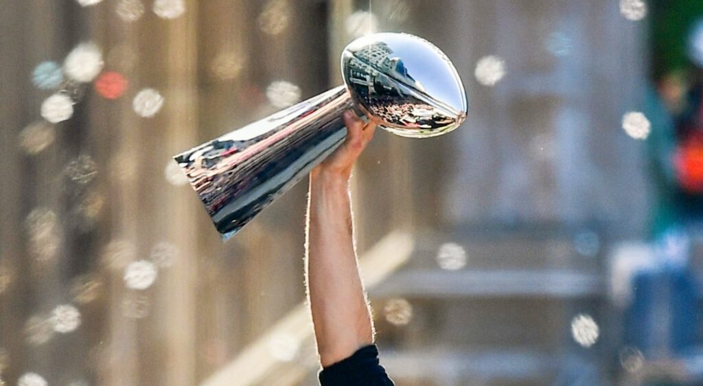 Tom Brady holding Vince Lombardi Trophy. The Lions are projected to win Super Bowl 59 in ESPN's new computer model.