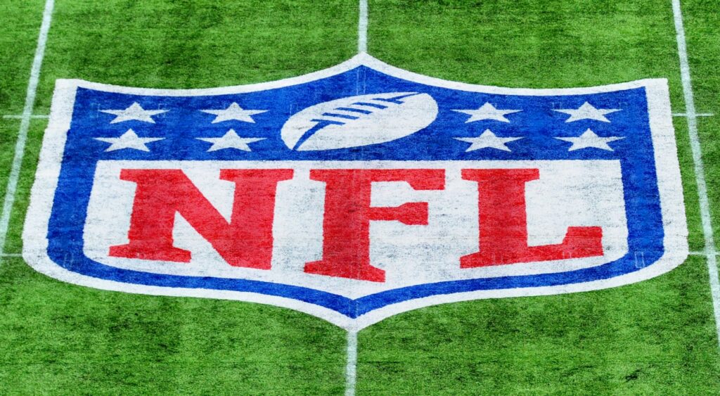 NFL logo shown on field. Jets quarterback Aaron Rodgers says his team has a "snitching" problem.