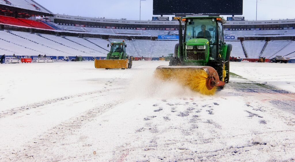 Tractors get rid of snow at Bills' Highmark Stadium.