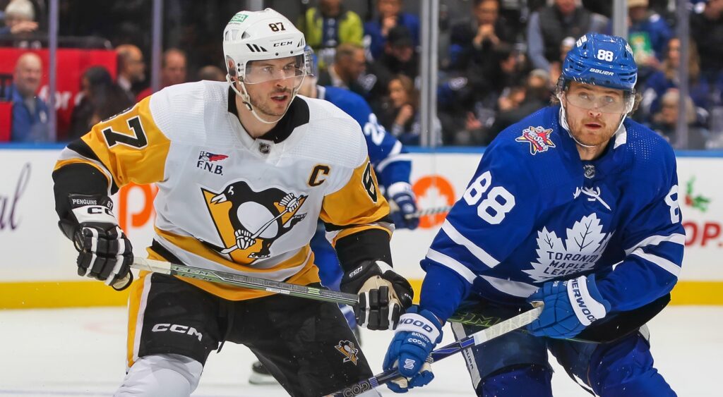 Sidney Crosby and William Nylander looking on in game.