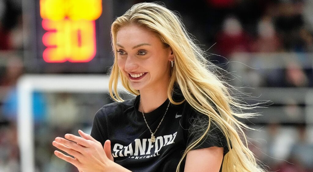 Cameron Brink smiling on the court in her street clothes.