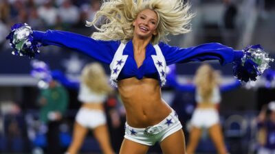 Dallas Cowboys cheerleader performing on field