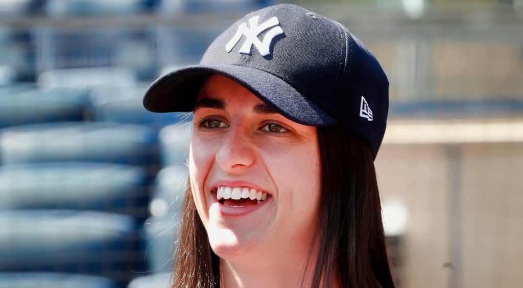 Caitlin Clark smiling in Yankees cap