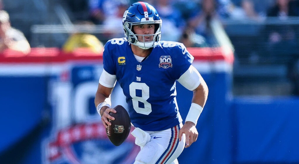 Daniel Jones holding football