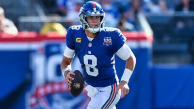 Daniel Jones holding football