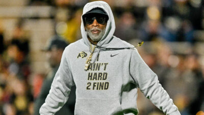 Colorado Buffaloes head coach Deion Sanders in grey hoodie