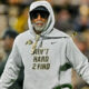 Colorado Buffaloes head coach Deion Sanders in grey hoodie