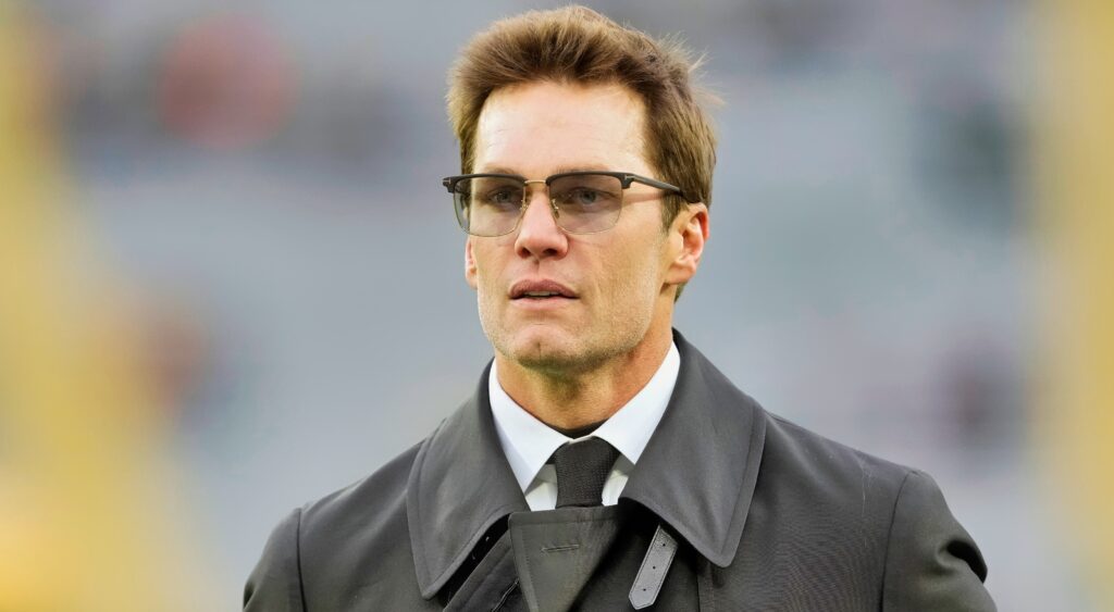 Tom Brady in suit and glasses