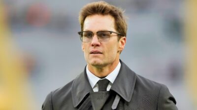 Tom Brady in suit and glasses